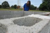 Pesquisadora Ayane Rodrigues confere os blocos que compõe um experimento de análise ambiental construído no campus da URI. Será coberto com telhas e irá recolher água da chuva para análise